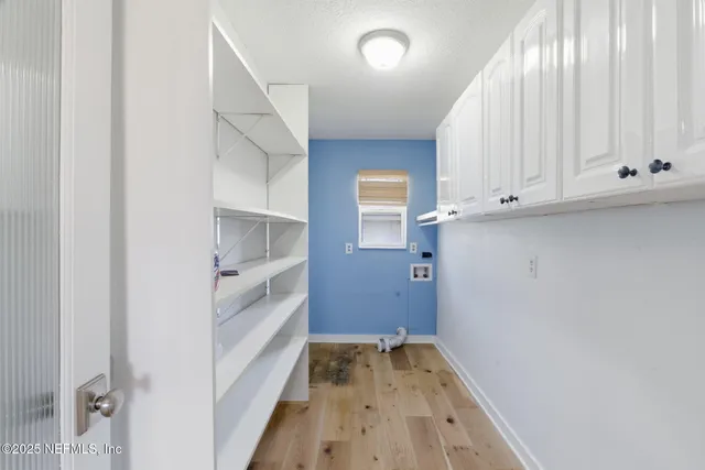 a view of a patio with table and chairs potted plants with wooden floor