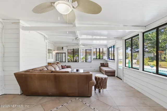 an aerial view of residential houses with outdoor space and ocean view