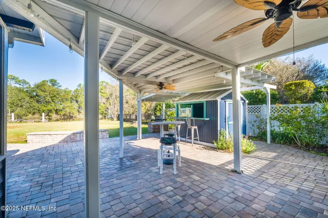 an aerial view of a house with swimming pool and porch
