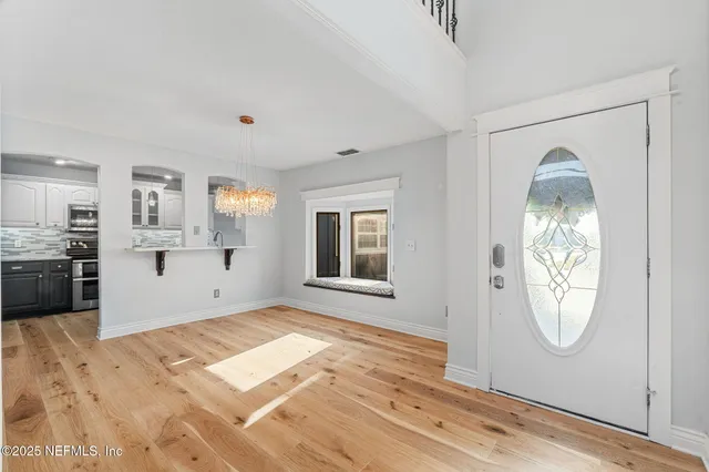 a view of a livingroom with wooden floor and a fireplace