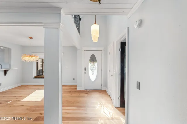 a view of staircase with railing and white walls