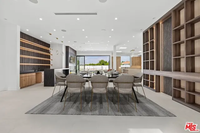 a living room with lots of furniture and a book shelf