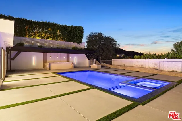 a view of a tennis ground with large trees