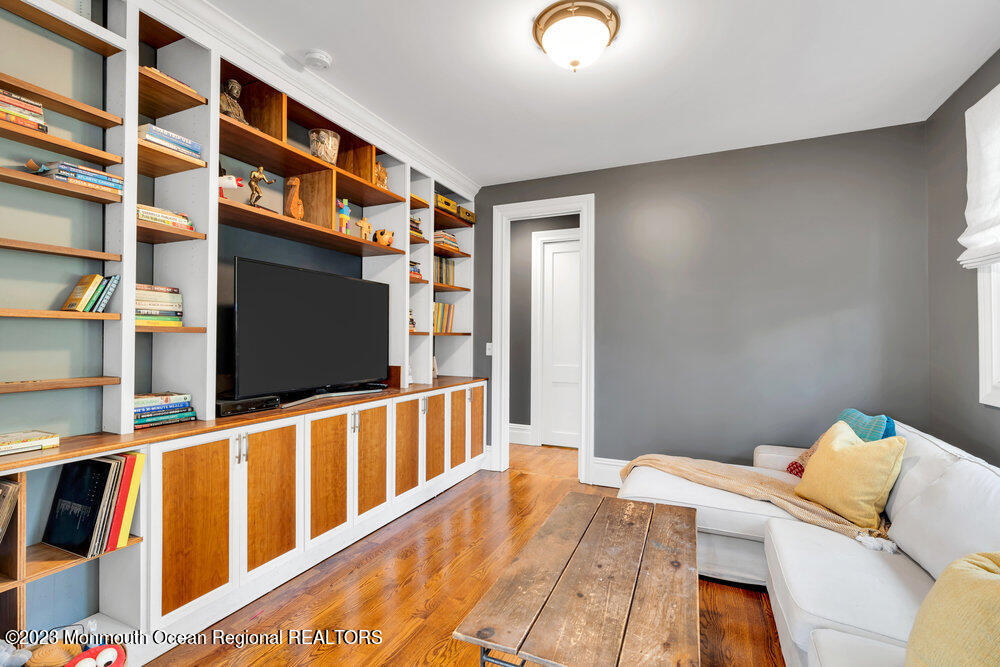 405 Brown Street Brielle, NJ 08730 - Photo 15 of 92 a bedroom with furniture and a flat screen tv