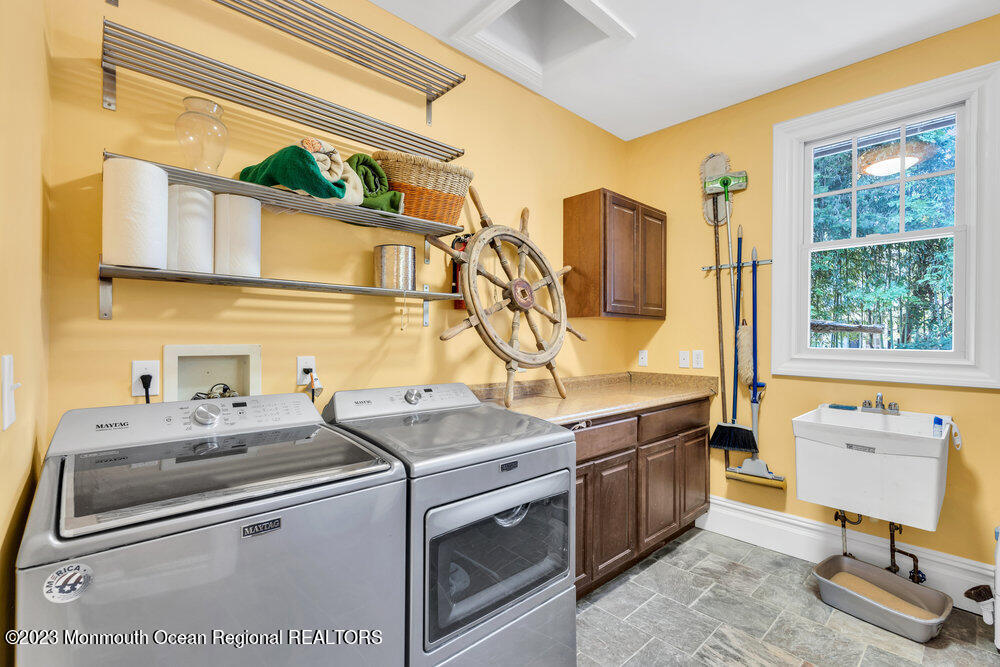 405 Brown Street Brielle, NJ 08730 - Photo 29 of 92 a kitchen with stainless steel appliances granite countertop a sink stove and refrigerator