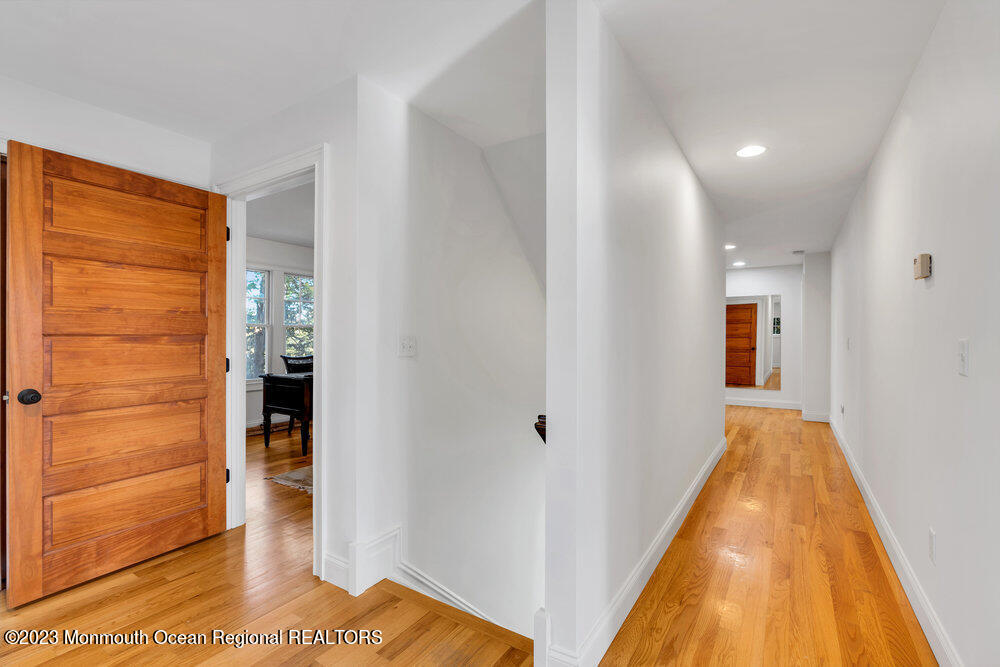 405 Brown Street Brielle, NJ 08730 - Photo 31 of 92 a view of a hallway with wooden floor and closet