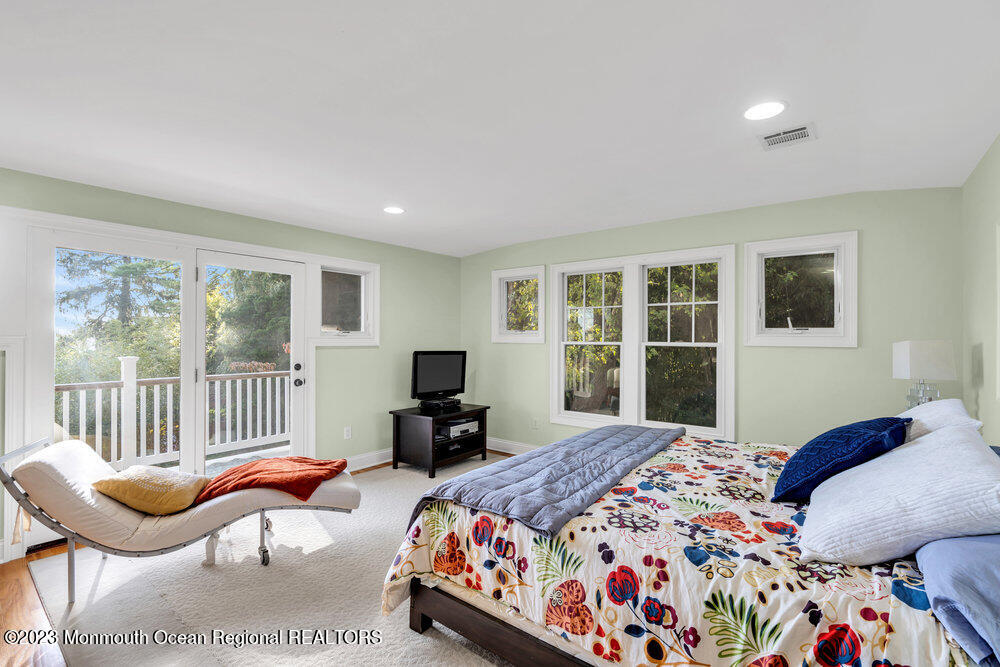 405 Brown Street Brielle, NJ 08730 - Photo 32 of 92 a bedroom with a bed and a view of balcony