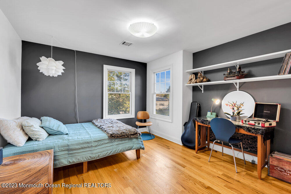 405 Brown Street Brielle, NJ 08730 - Photo 42 of 92 a bedroom with furniture and a wooden floor