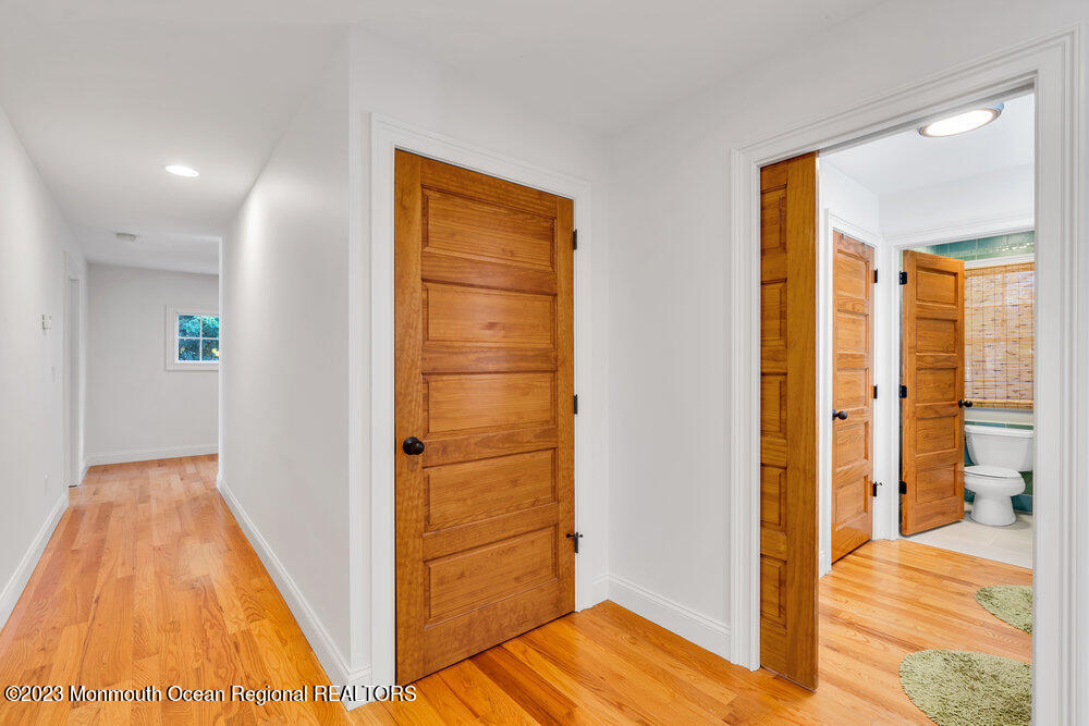405 Brown Street Brielle, NJ 08730 - Photo 48 of 92 a view of a hallway with wooden floor and bedroom