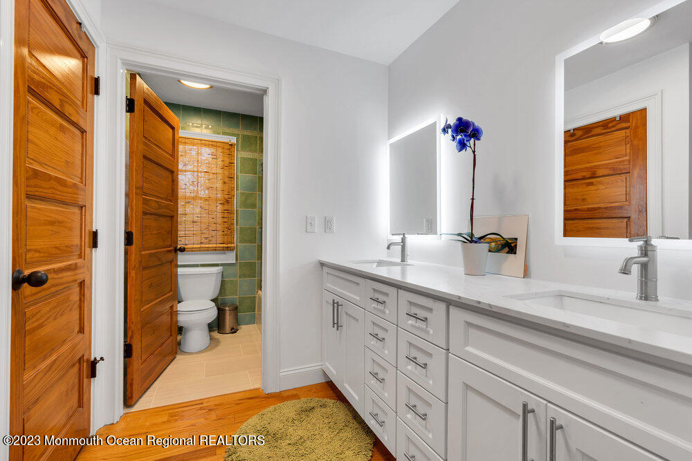 405 Brown Street Brielle, NJ 08730 - Photo 49 of 92 a bathroom with a double vanity sink toilet and shower