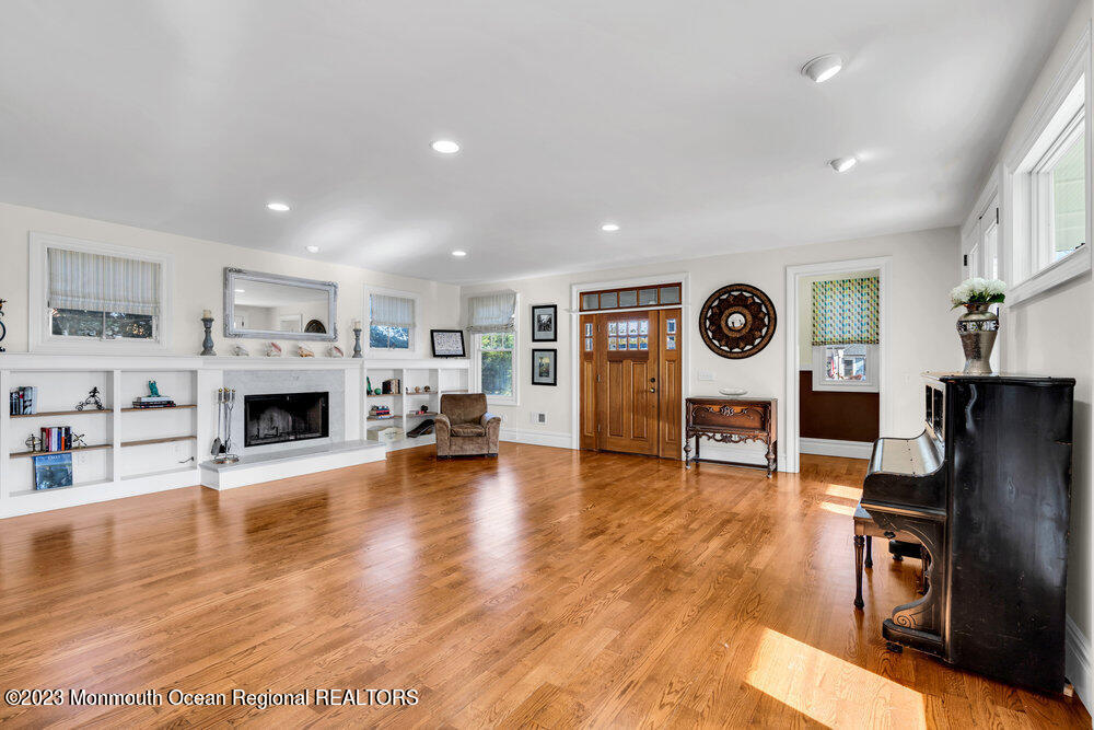 405 Brown Street Brielle, NJ 08730 - Photo 9 of 92 a living room with furniture a fireplace and a flat screen tv