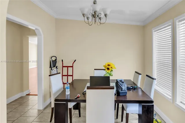 a view of a dining room with furniture and chandelier
