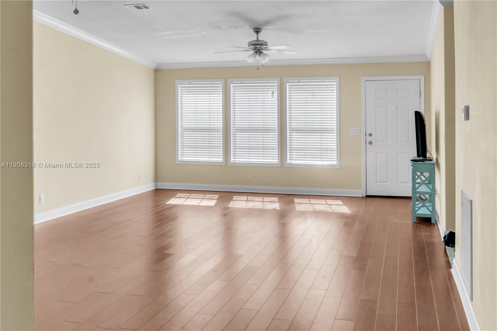 11341 Pruett Road Seffner, FL 33584 - Photo 14 of 50 an empty room with wooden floor and windows