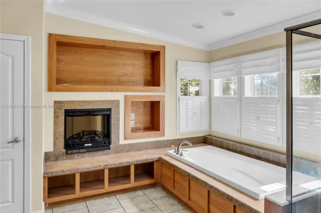 a bathroom with a tub sink and mirror