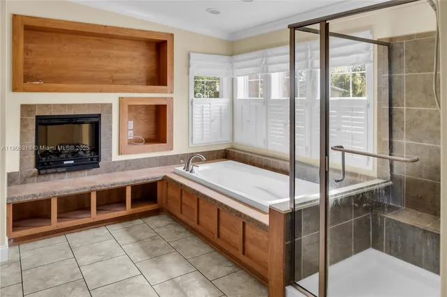 a spacious bathroom with a granite countertop double vanity and a mirror