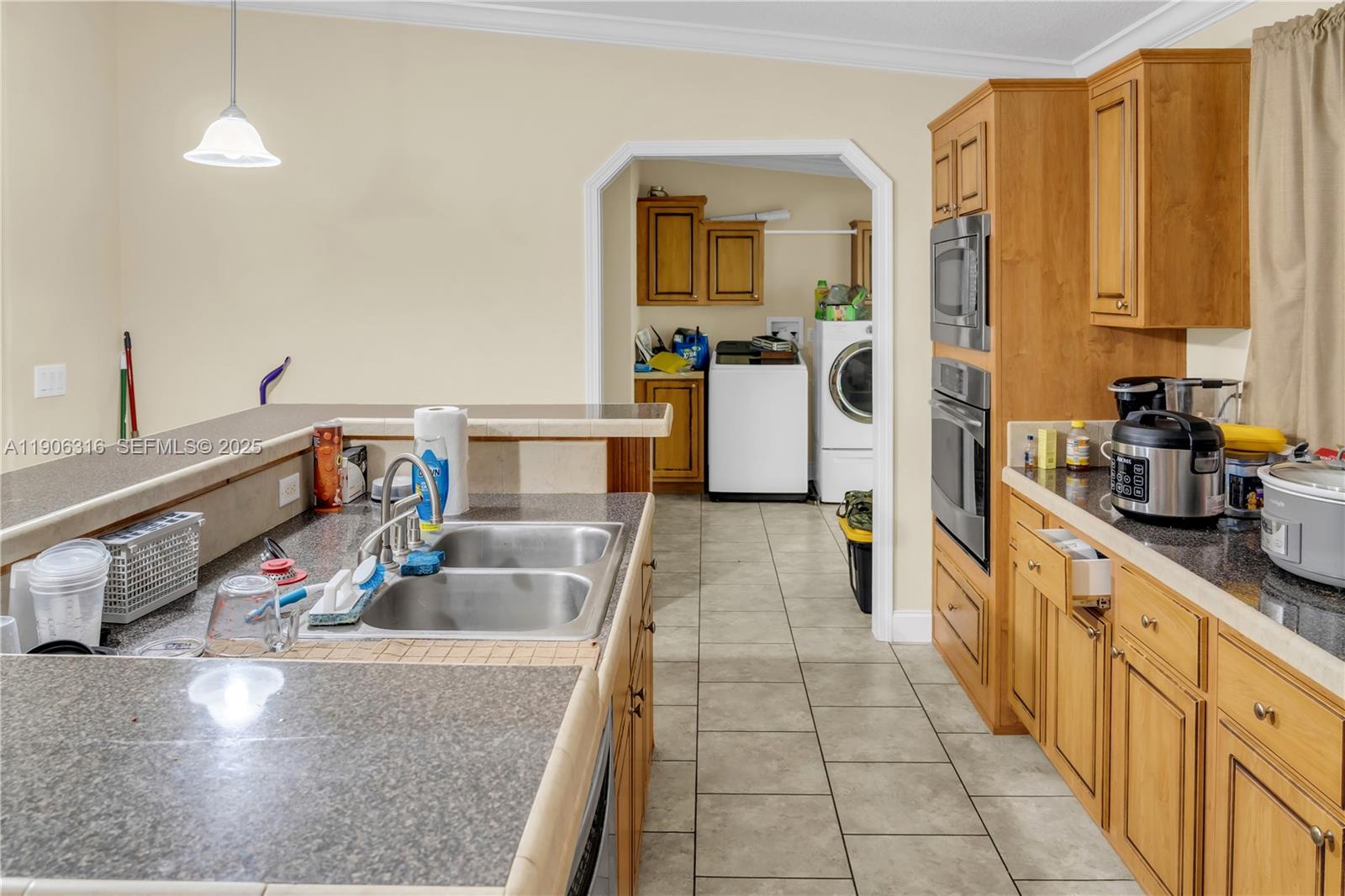 11341 Pruett Road Seffner, FL 33584 - Photo 30 of 50 a kitchen with stainless steel appliances granite countertop a sink counter space and cabinets