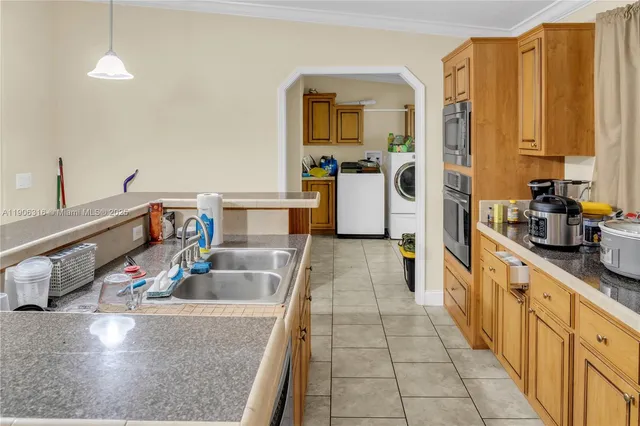a kitchen with stainless steel appliances granite countertop a sink counter space and cabinets