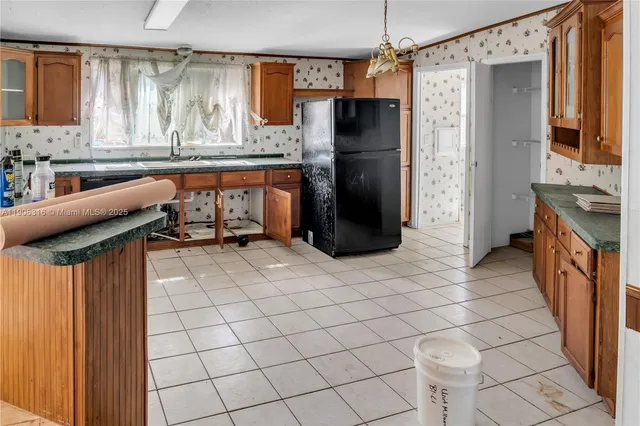 a kitchen with stainless steel appliances granite countertop a refrigerator and a stove