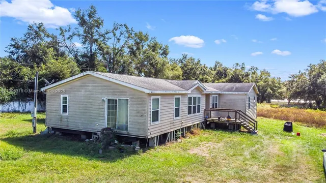 a view of a house with a yard and roof