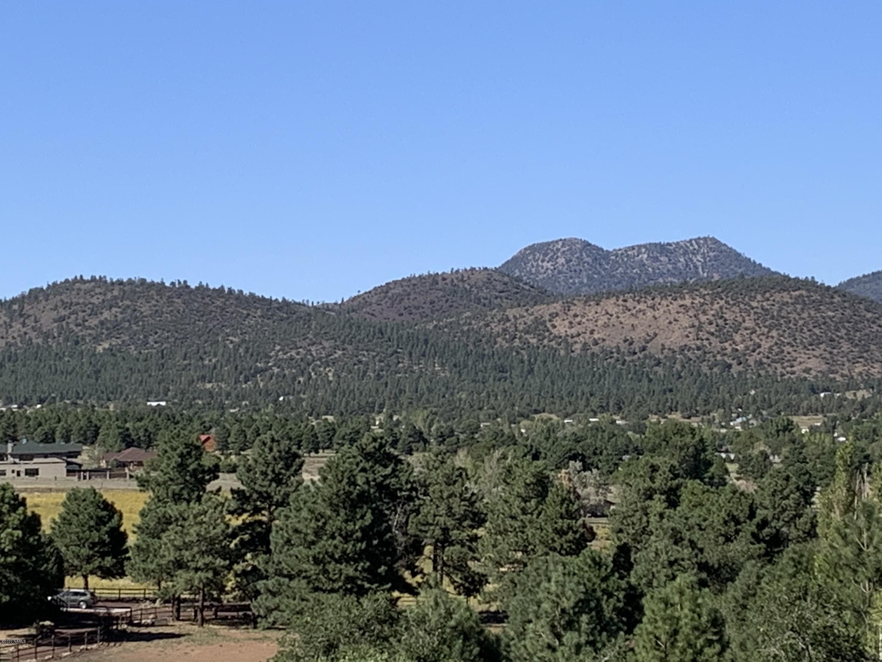 11668 North Rope Arabian Road, Unit 2 Flagstaff, AZ 86004 - Photo 11 of 11 a view of a town with mountains in the background