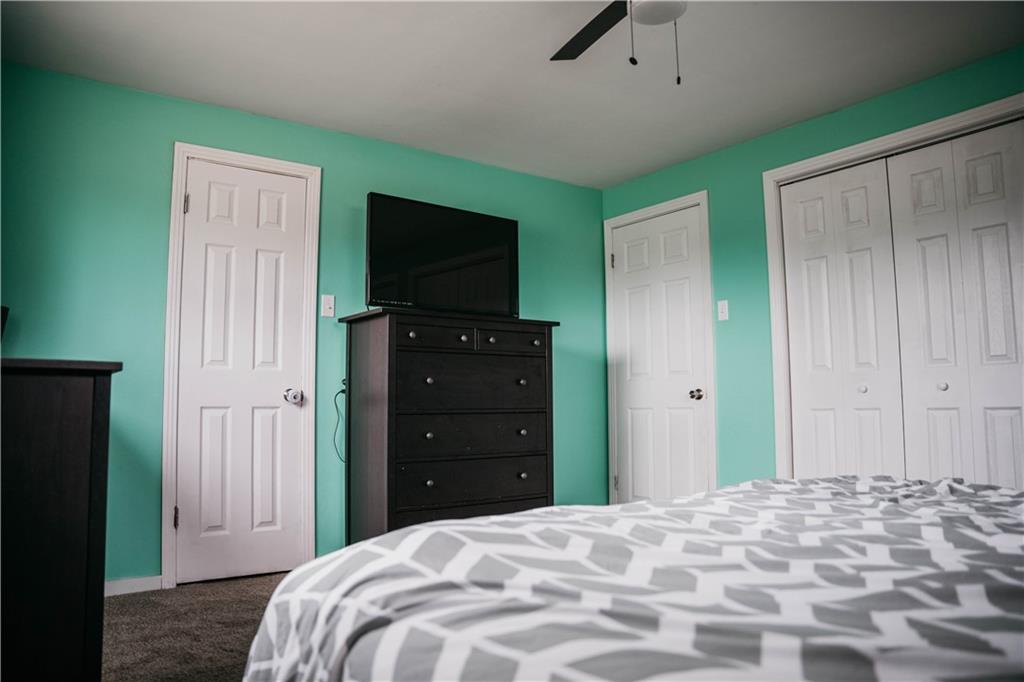 14475 Roberta Drive Irwin, PA 15642 - Photo 13 of 21 a bedroom with a bed and a flat tv screen on dresser