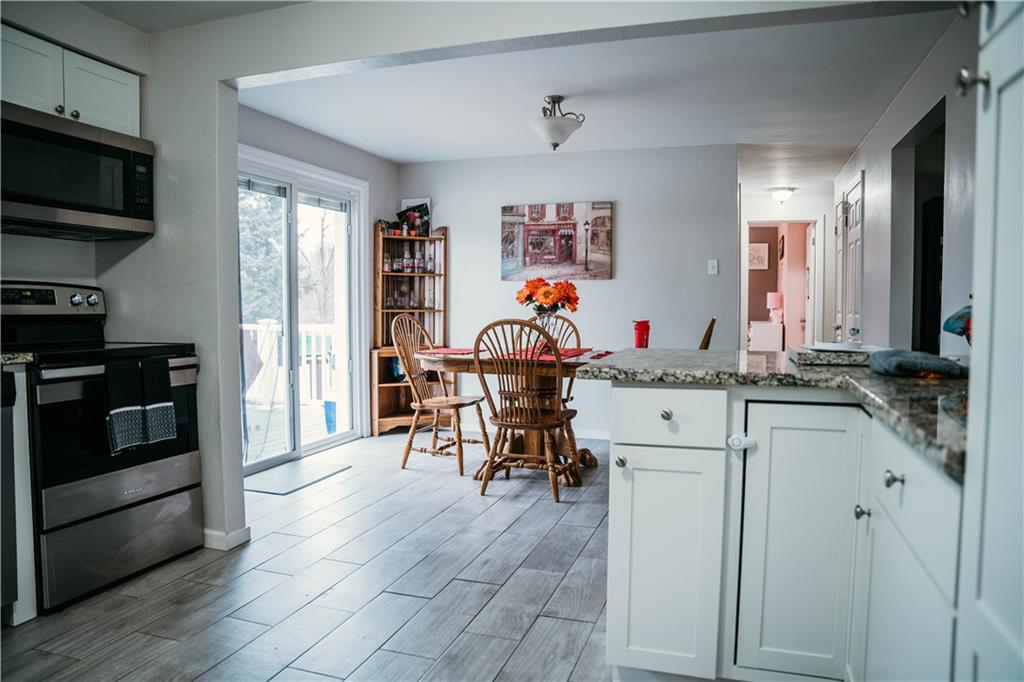 14475 Roberta Drive Irwin, PA 15642 - Photo 7 of 21 a kitchen with stainless steel appliances kitchen island granite countertop a stove and a sink