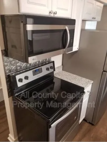 a stove top oven sitting inside of a kitchen