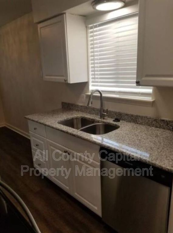 3415 Willowrun Drive, Unit C Austin, TX 78704 - Photo 6 of 9 a kitchen with granite countertop a sink a stove and cabinets