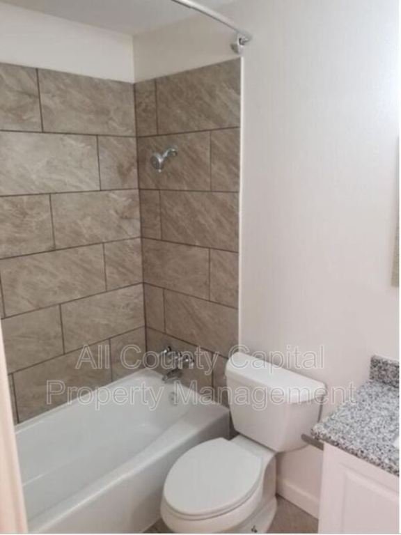 3415 Willowrun Drive, Unit C Austin, TX 78704 - Photo 8 of 9 a white toilet and tub sitting next to a bathroom sink