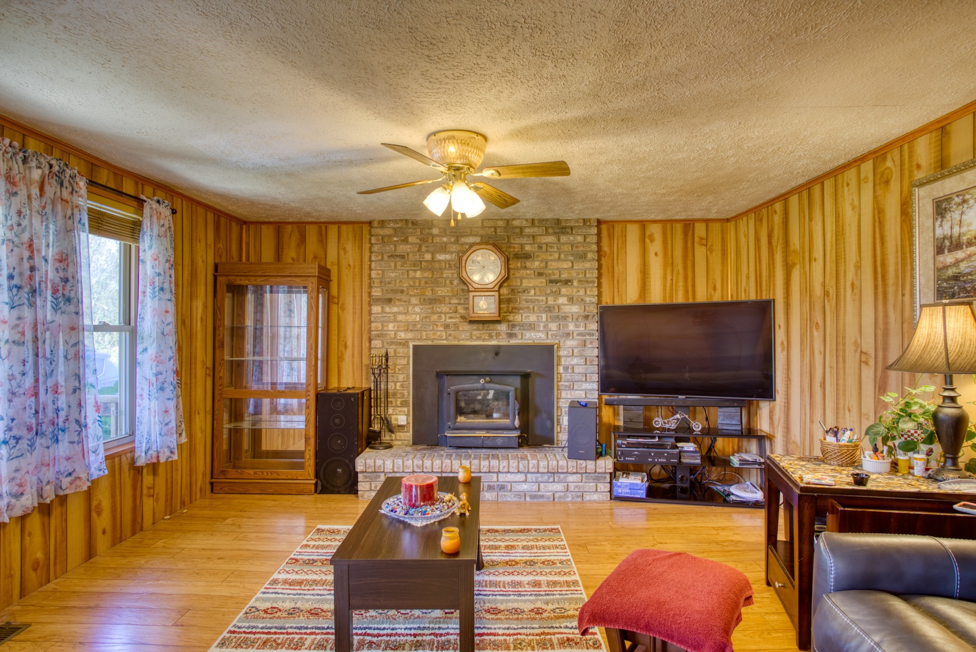 738 Pugh Road Crossville, TN 38555 - Photo 16 of 26 a living room with furniture a fireplace and a flat screen tv