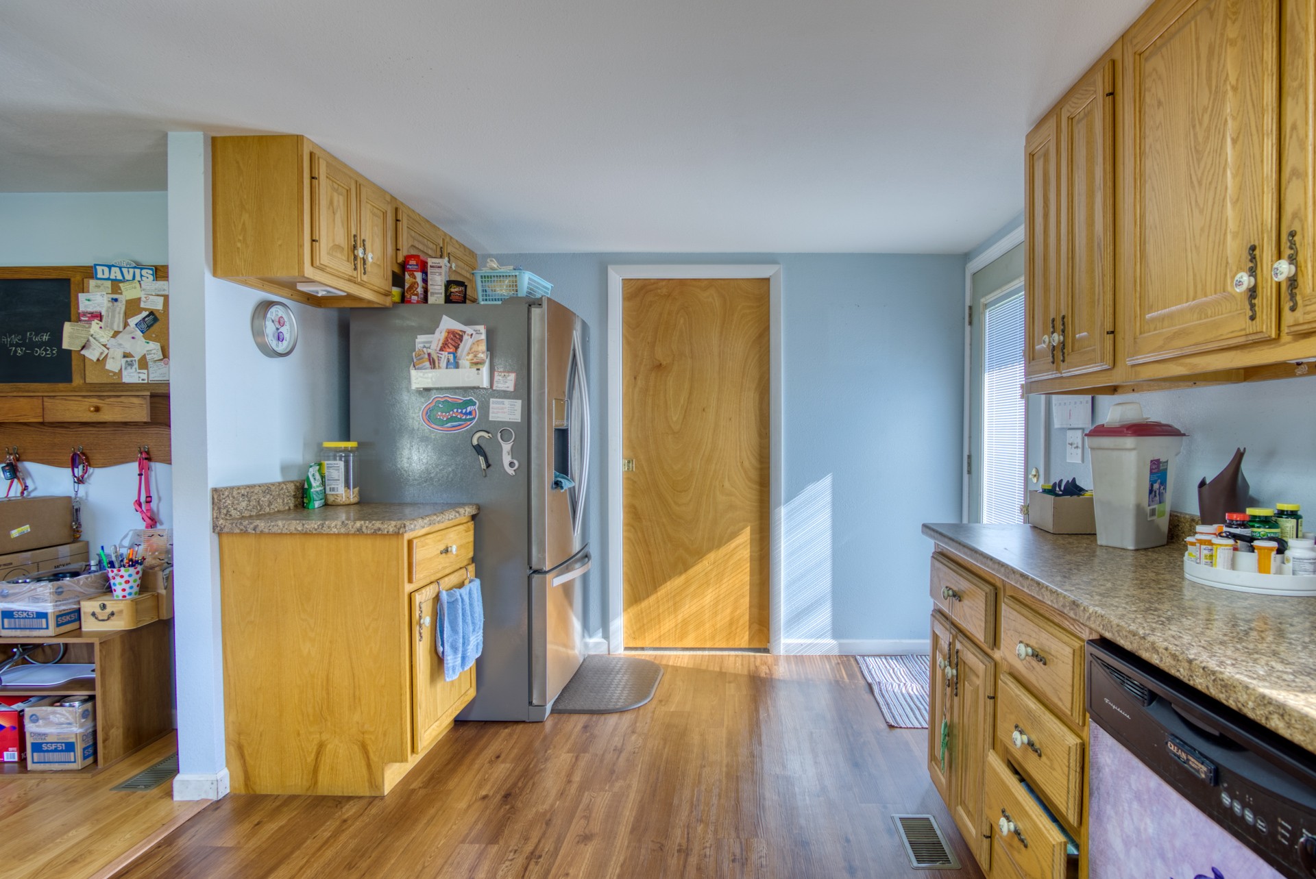 738 Pugh Road Crossville, TN 38555 - Photo 18 of 26 a kitchen with stainless steel appliances granite countertop a refrigerator a sink dishwasher and wooden cabinets with wooden floor