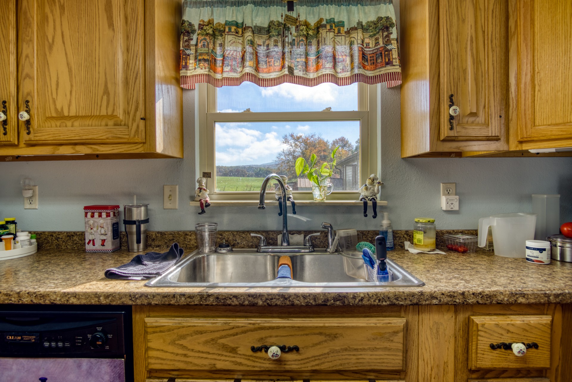 738 Pugh Road Crossville, TN 38555 - Photo 20 of 26 a kitchen with granite countertop a sink a stove and a wooden cabinets