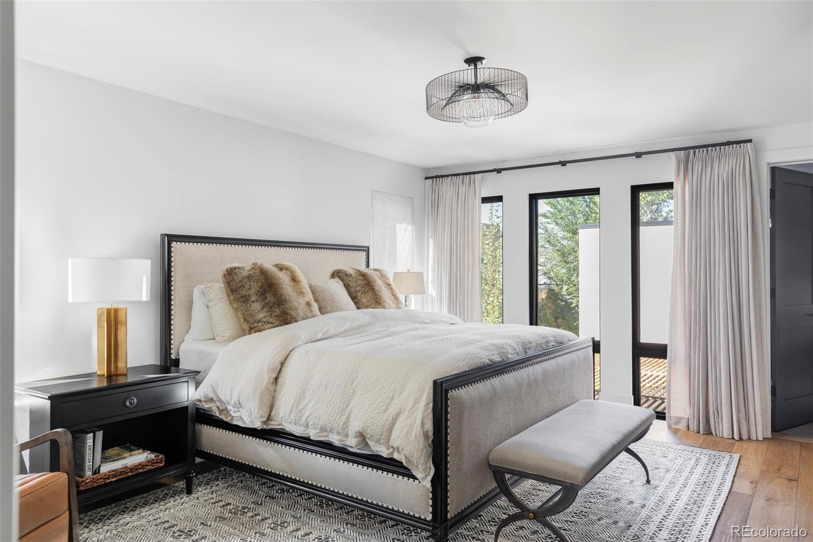 255 Jackson Street Denver, CO 80206 - Photo 13 of 32 a bedroom with a bed and wooden floor
