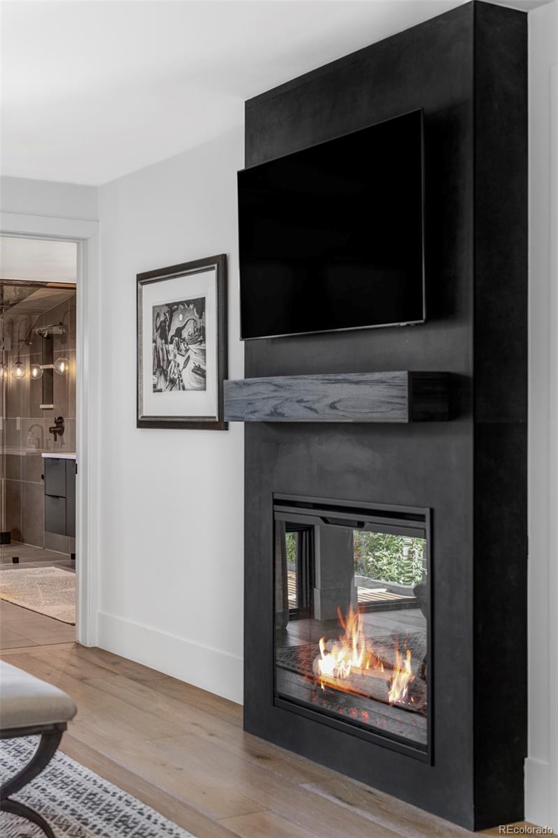 255 Jackson Street Denver, CO 80206 - Photo 14 of 32 a living room with a fireplace and a flat screen tv
