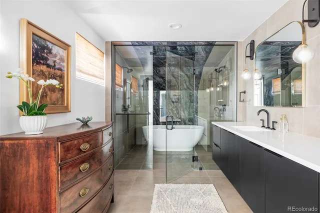 a spacious bathroom with a double vanity sink a large mirror and a bathtub