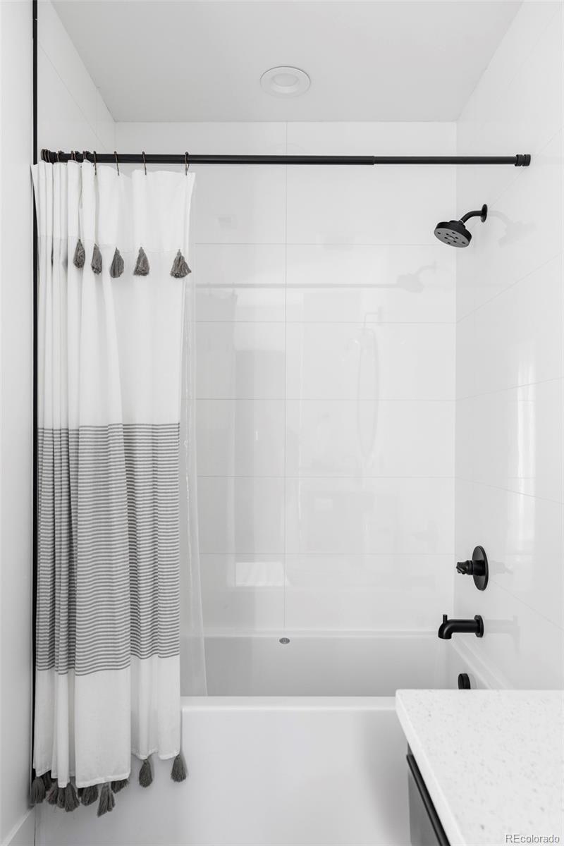 255 Jackson Street Denver, CO 80206 - Photo 18 of 32 a bathroom with a bathtub and a shower