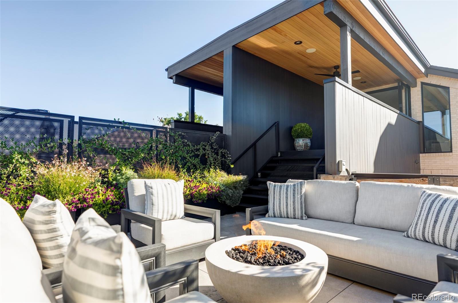 255 Jackson Street Denver, CO 80206 - Photo 23 of 32 a view of a patio with couches and a potted plant on a table