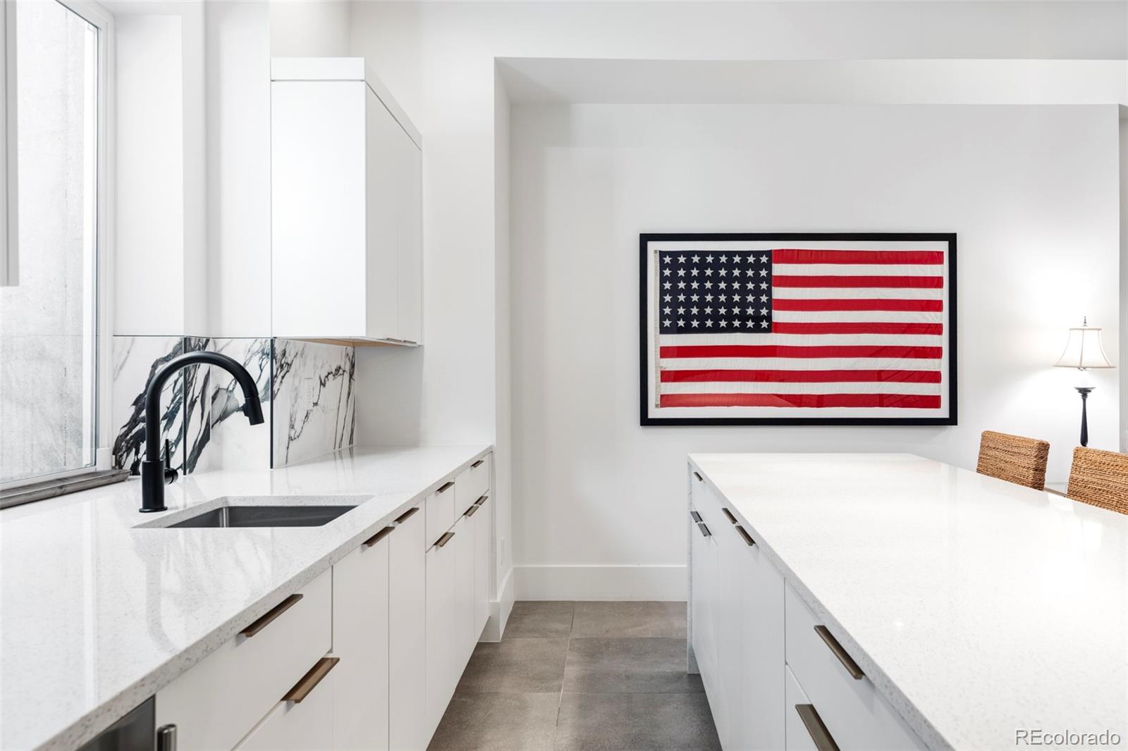 255 Jackson Street Denver, CO 80206 - Photo 27 of 32 a kitchen with a sink and a kitchen island