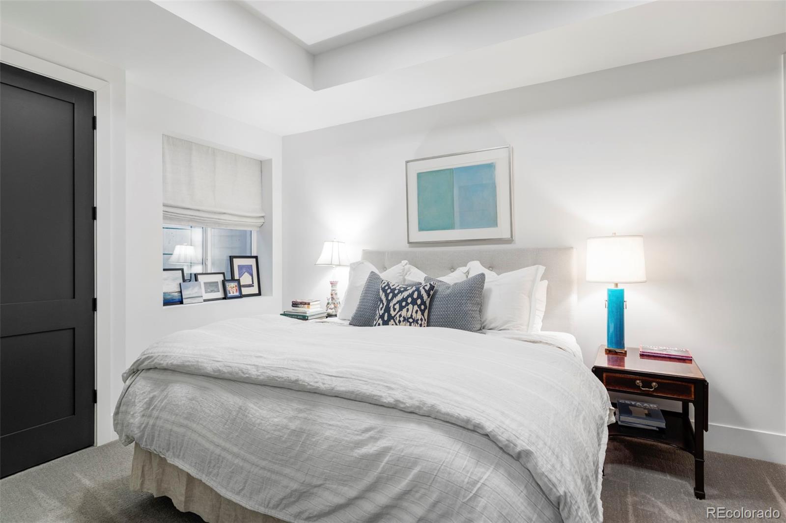 255 Jackson Street Denver, CO 80206 - Photo 30 of 32 a bedroom with bed and a night stand