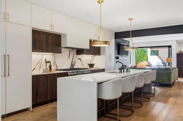 a kitchen with kitchen island a dining table and chairs