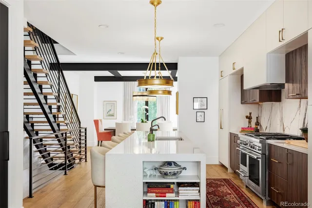 a living room with furniture a flat screen tv and a view of kitchen