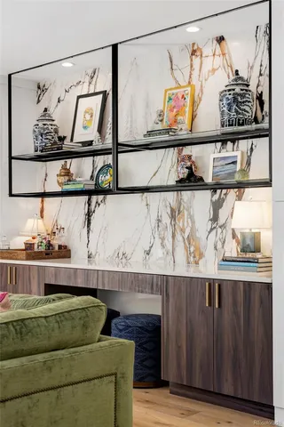 a living room with a couch and painting on the wall