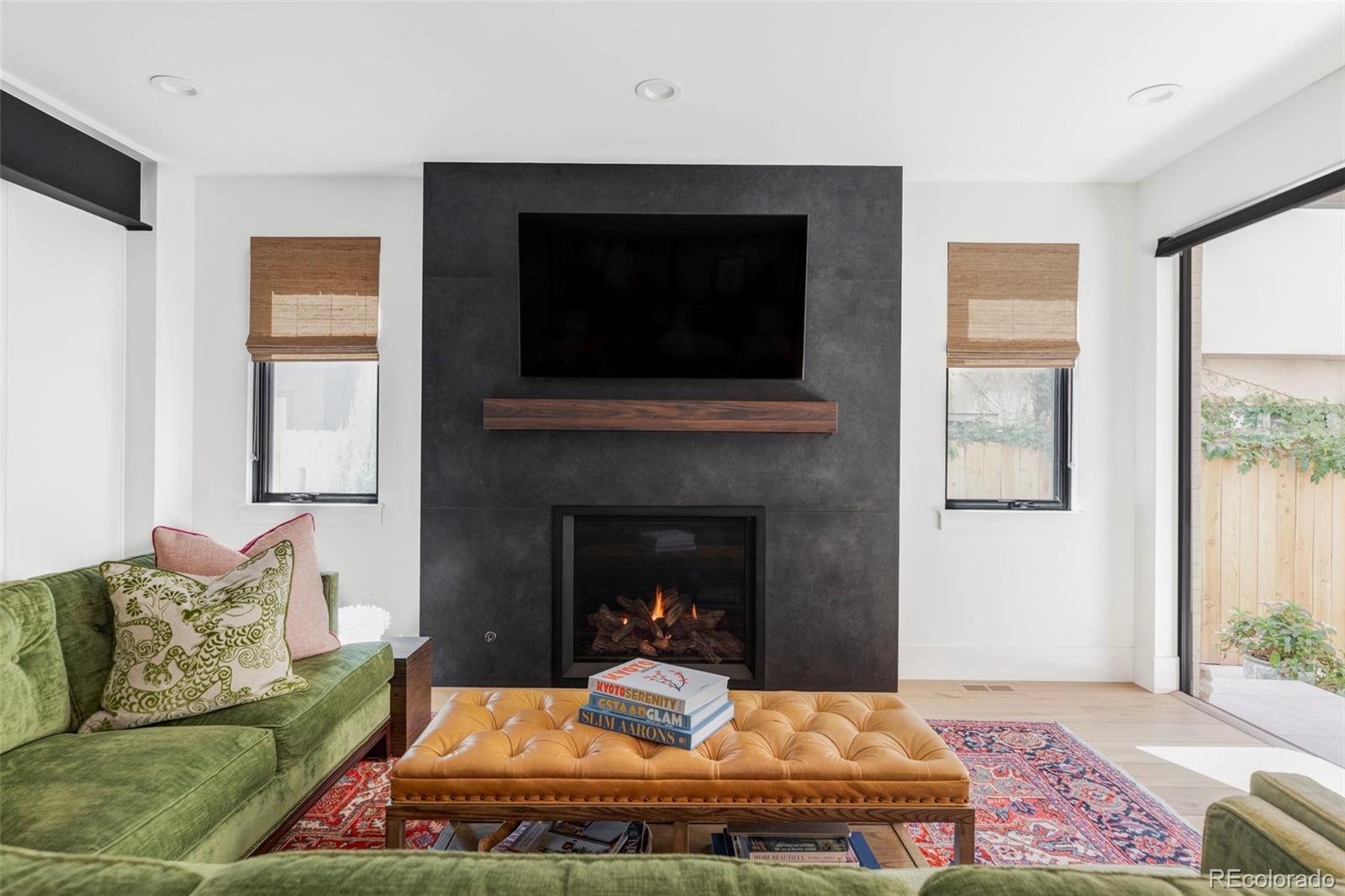 255 Jackson Street Denver, CO 80206 - Photo 9 of 32 a living room with furniture and a fireplace