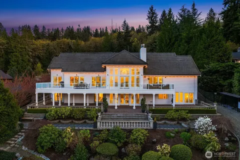 a front view of a house with a yard and outdoor seating