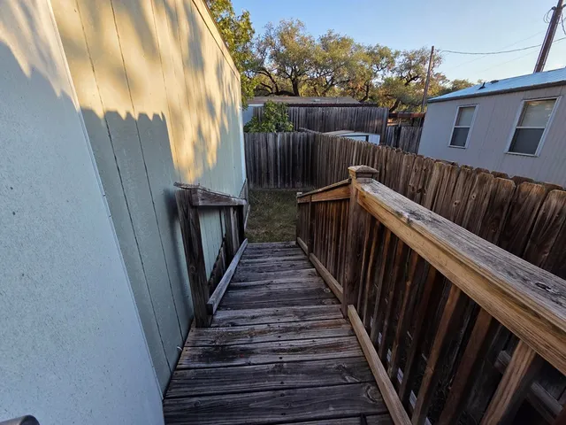 a view of balcony with wooden floor and stairs