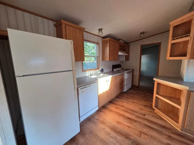 a kitchen with stainless steel appliances a refrigerator sink and microwave