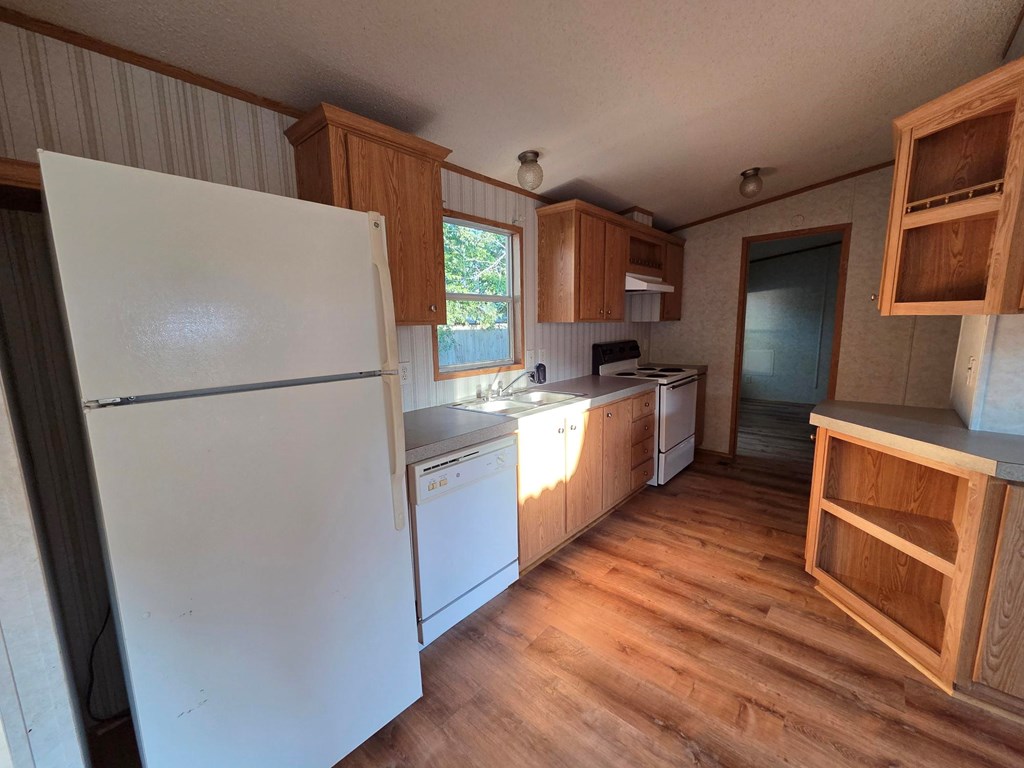 167-2 Beaumont Street Bandera, TX 78003 - Photo 7 of 17 a kitchen with stainless steel appliances a refrigerator sink and microwave