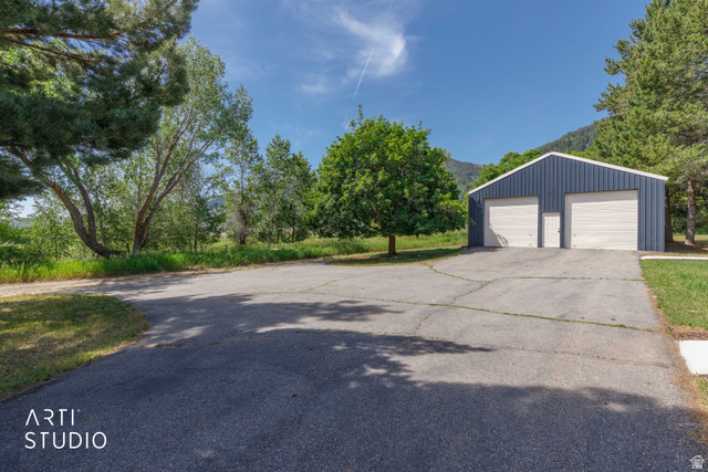 2807 North Ogden Canyon Road Eden, UT 84310 - Photo 45 of 72 Blue metal-sided outbuilding featuring two garage doors and a single access door
