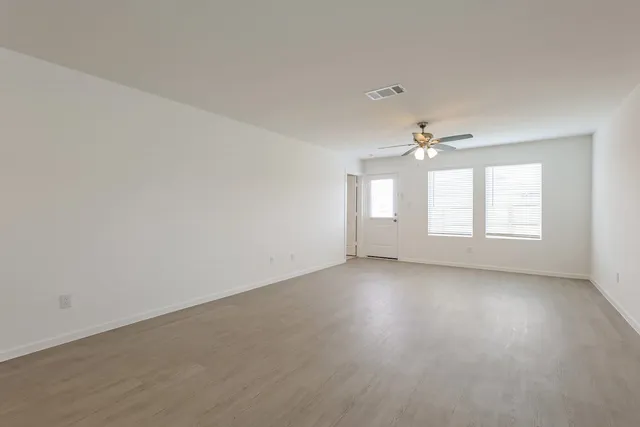 a view of an empty room with a window