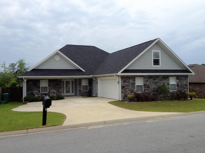 a front view of house with yard and green space